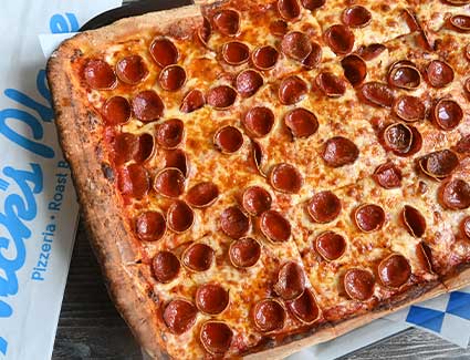 Nick's large place pepperoni party pan pizza.