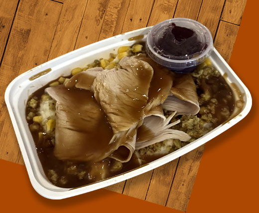 Gobbler Bowls are fresh oven roasted Thanksgiving turkey, sliced over homemade stuffing, sweet corn, and homemade mashed potatoes topped off with brown gravy and cranberry sauce on the side.